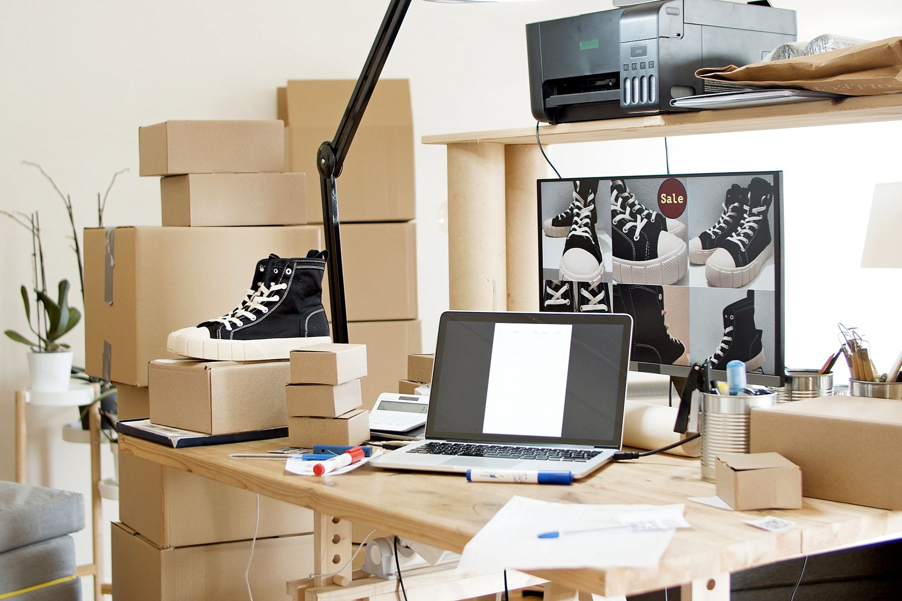 Ecommerce launch workspace with products, packaging, laptop and content planning