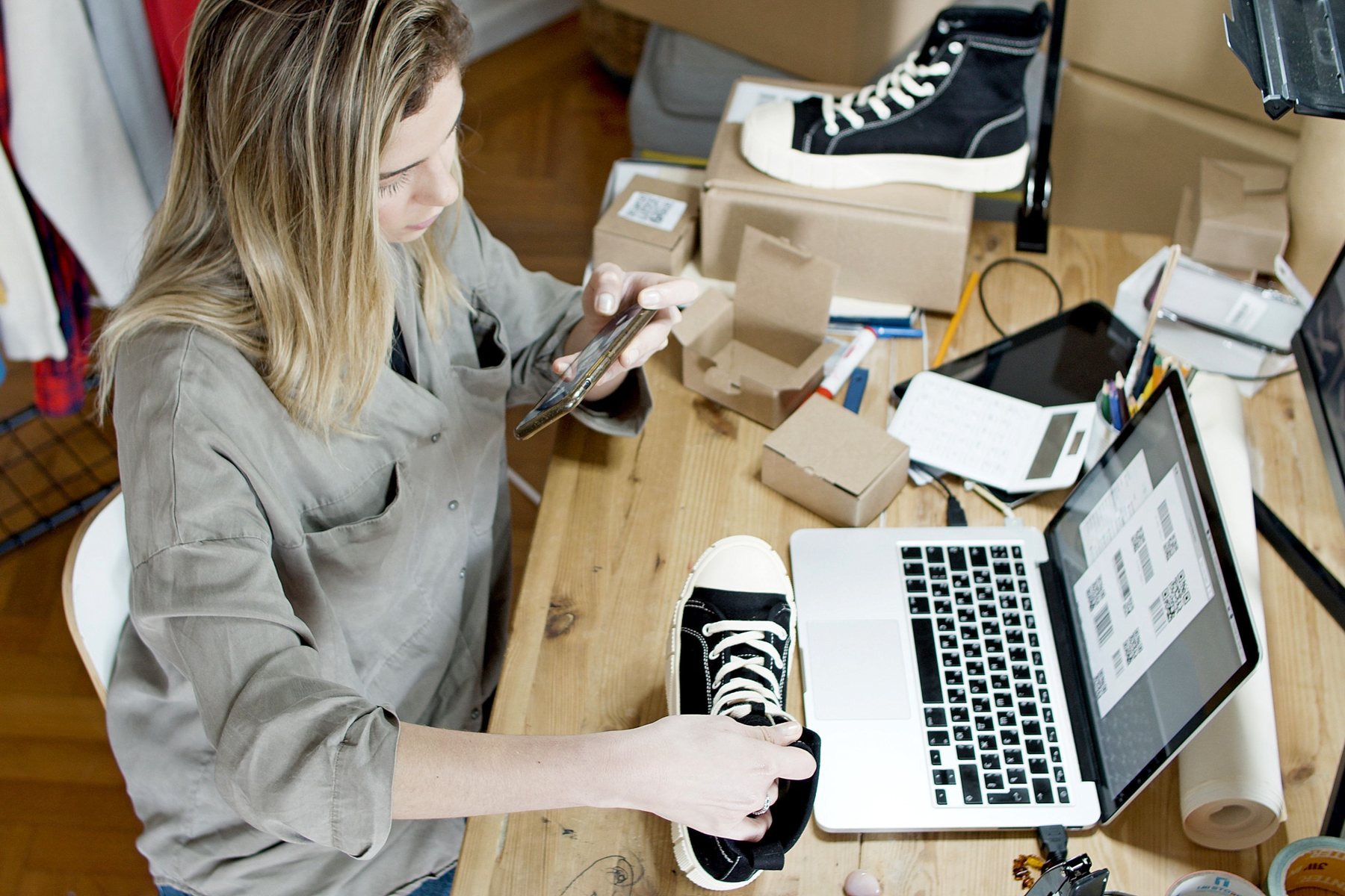 Ecommerce operator reviewing product content and imagery beside inventory